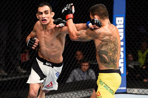 MEXICO CITY, MEXICO - NOVEMBER 05:  (L-R) Tony Ferguson of the United States punches Rafael Dos Anjos of Brazil in their lightweight bout during the UFC Fight Night event at Arena Ciudad de Mexico on November 5, 2016 in Mexico City, Mexico. (Photo by Jeff Bottari/Zuffa LLC/Zuffa LLC via Getty Images)