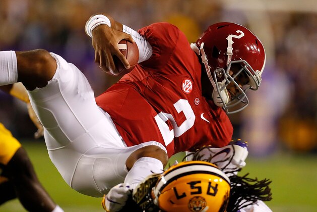 BATON ROUGE, LA - NOVEMBER 05:  Jalen Hurts #2 of the Alabama Crimson Tide leaps backwards for extra yardage over Donte Jackson #1 of the LSU Tigers at Tiger Stadium on November 5, 2016 in Baton Rouge, Louisiana.  (Photo by Kevin C. Cox/Getty Images)