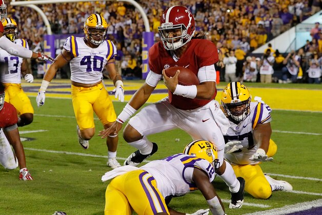 BATON ROUGE, LA - NOVEMBER 05:  Jalen Hurts #2 of the Alabama Crimson Tide leaps for a first down against Tre'Davious White #18 and Davon Godchaux #57 of the LSU Tigers at Tiger Stadium on November 5, 2016 in Baton Rouge, Louisiana.  (Photo by Kevin C. Cox/Getty Images)