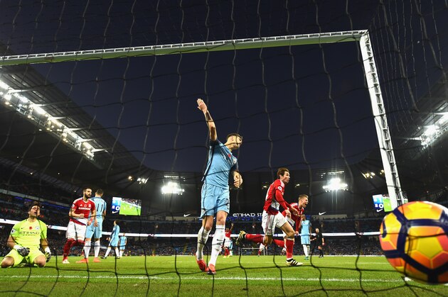 MANCHESTER, ENGLAND - NOVEMBER 05:  John Stones of Manchester City (C) attempts to stop Marten de Roon of Middlesbrough (R) scoring during the Premier League match between Manchester City and Middlesbrough at Etihad Stadium on November 5, 2016 in Manchester, England.  (Photo by Laurence Griffiths/Getty Images)