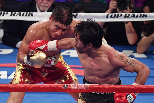 LAS VEGAS, NV - NOVEMBER 05:  Manny Pacquiao (R) hits Jessie Vargas iwith a right in the 12th round of their WBO welterweight championship fight at the Thomas & Mack Center on November 5, 2016 in Las Vegas, Nevada. Pacquiao won by unanimous decision.  (Photo by Ethan Miller/Getty Images)