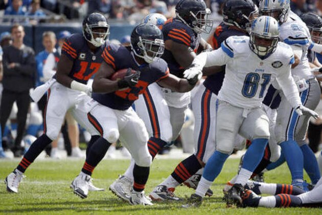 Chicago Bears running back Joique Bell (43) runs against Detroit Lions defensive end Kerry Hyder (61) during the first half of an NFL football game, Sunday, Oct. 2, 2016, in Chicago. (AP Photo/Nam Y. Huh)