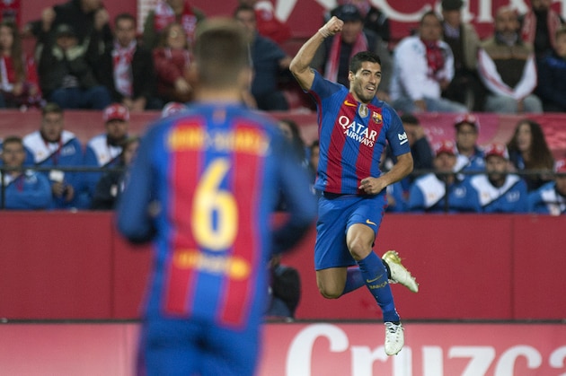 Barcelona's Uruguayan forward Luis Suarez (R) celebrates after scoring during the Spanish league football match Sevilla FC vs FC Barcelona at the Ramon Sanchez Pizjuan stadium in Sevilla on November 6, 2016. / AFP / JORGE GUERRERO        (Photo credit should read JORGE GUERRERO/AFP/Getty Images)