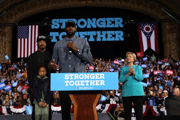 CLEVELAND, OH - NOVEMBER 06:  LeBron James (C) speaks as Democratic presidential nominee former Secretary of State Hillary Clinton (R) and J.R. Smith (L) look on during a campaign rally at the Cleveland Public Auditorium on November 6, 2016 in Cleveland, Ohio. With two days to go until election day, Hillary Clinton is campaigning in Florida and Pennsylvania.  (Photo by Justin Sullivan/Getty Images)