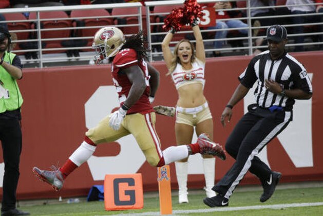 San Francisco 49ers running back DuJuan Harris leaps over the goal line after scoring a touchdown on a 47-yard run during the first half of an NFL football game against the New Orleans Saints Sunday, Nov. 6, 2016, in Santa Clara, Calif. (AP Photo/Tony Avelar)