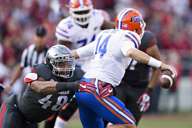 FAYETTEVILLE, AR - NOVEMBER 5:  Deatrich Wise Jr. #48 of the Arkansas Razorback tackles Luke Del Rio #14 of the Florida Gators at Razorback Stadium on November 5, 2016 in Fayetteville, Arkansas.  The Razorbacks defeated the Gators 31-10.  (Photo by Wesley Hitt/Getty Images)