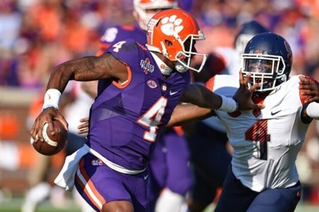 Clemson quarterback Deshaun Watson avoids the tackle attempt by Syracuse's Zaire Franklin to gain a first down during the first half of an NCAA college football game Saturday, Nov. 5, 2016,  in Clemson,  S.C. Clemson won 54-0.  (AP Photo/Richard Shiro)