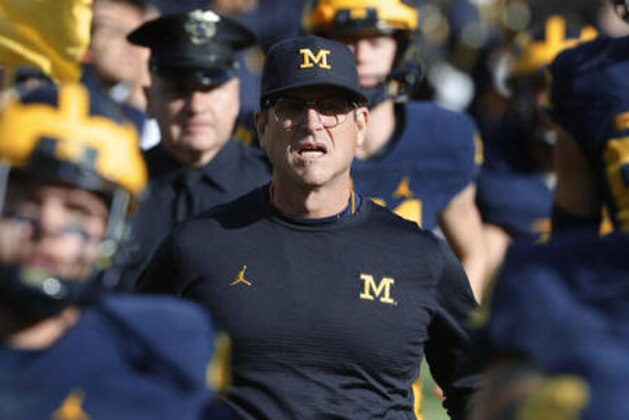 Michigan Wolverines head coach Jim Harbaugh runs onto the field before an NCAA college football game against the Maryland Terrapins in Ann Arbor, Mich., Saturday, Nov. 5, 2016. (AP Photo/Paul Sancya)