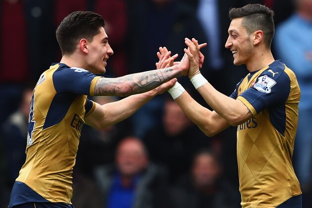 LONDON, UNITED KINGDOM - APRIL 09:  Mesut Ozil (R) of Arsenal celebrates scoring his team's first goal with his team mate Hector Bellerin (L) during the Barclays Premier League match between West Ham United and Arsenal at the Boleyn Ground on April 9, 2016 in London, England.  (Photo by Clive Rose/Getty Images)