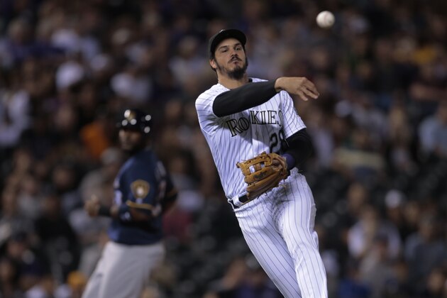DENVER, CO - OCTOBER 1: Nolan Arenado #28 of the Colorado Rockies throws to first base against the Milwaukee Brewers in the eighth inning at Coors Field on October 1, 2016 in Denver, Colorado. (Photo by Joe Mahoney/Getty Images)