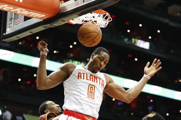 FILE - In this Oct. 10, 2016, file photo, Atlanta Hawks center Dwight Howard (8) scores against the Cleveland Cavaliers in the first half of an exhibition NBA basketball game in Atlanta. One of the most intriguing storylines of the NBA season could be in Atlanta, where Howard and the Hawks are hoping they'll be just what the other needs to recapture what they once had.  (AP Photo/John Bazemore, File)