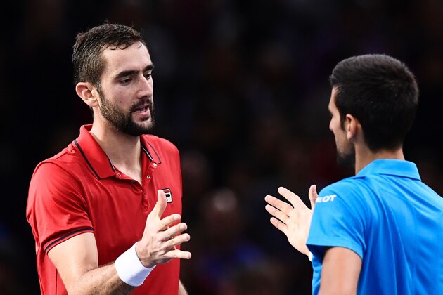 Croatia's Marin Cilic (L) shakes hands with Serbia's Novak Djokovic after winning their quarter-final tennis match at the ATP World Tour Masters 1000 indoor tournament in Paris on November 4, 2016. / AFP / MIGUEL MEDINA        (Photo credit should read MIGUEL MEDINA/AFP/Getty Images)