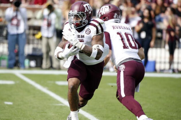 Texas A&M running back Trayveon Williams (5) takes a hand off from quarterback Jake Hubenak (10) as he runs against Mississippi State in the first half of an NCAA college football game in Starkville, Miss., Saturday, Nov. 5, 2016. Mississippi State won 35-28. (AP Photo/Rogelio V. Solis)