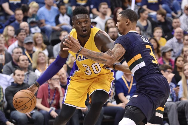 SALT LAKE CITY, UT - OCTOBER 28: Julius Randle #30 of the Los Angeles Lakers drives around defender George Hill #3 of the Utah Jazz at Vivint Smart Home Arena on October 28, 2016 in Salt Lake City, Utah. NOTE TO USER: User expressly acknowledges and agrees that, by downloading and or using this photograph, User is consenting to the terms and conditions of the Getty Images License Agreement. (Photo by Gene Sweeney Jr/Getty Images)