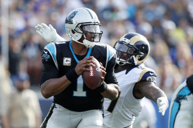Carolina Panthers quarterback Cam Newton, left, is sacked by Los Angeles Rams defensive end Eugene Sims during the first half of an NFL football game, Sunday, Nov. 6, 2016, in Los Angeles. (AP Photo/Ryan Kang)