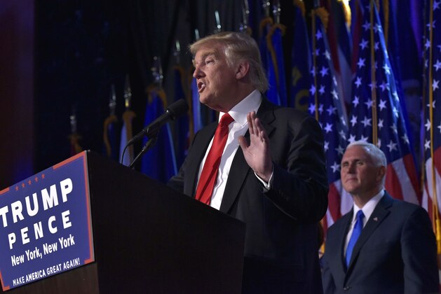 Republican presidential elect Donald Trump (L) gives a speech next to his Vice President elect Mike Pence (R) during election night at the New York Hilton Midtown in New York on November 9, 2016. 
Trump stunned America and the world Wednesday, riding a wave of populist resentment to defeat Hillary Clinton in the race to become the 45th president of the United States. / AFP / MANDEL NGAN        (Photo credit should read MANDEL NGAN/AFP/Getty Images)