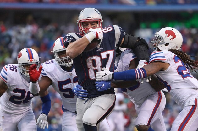 ORCHARD PARK, NY - OCTOBER 30: Rob Gronkowski #87 of the New England Patriots runs with the ball during NFL game action as Robert Blanton #26 of the Buffalo Bills and Zach Brown #53 and Jonathan Meeks #36 and Stephon Gilmore #24 gang tackle him at New Era Field on October 30, 2016 in Orchard Park, New York. (Photo by Tom Szczerbowski/Getty Images)