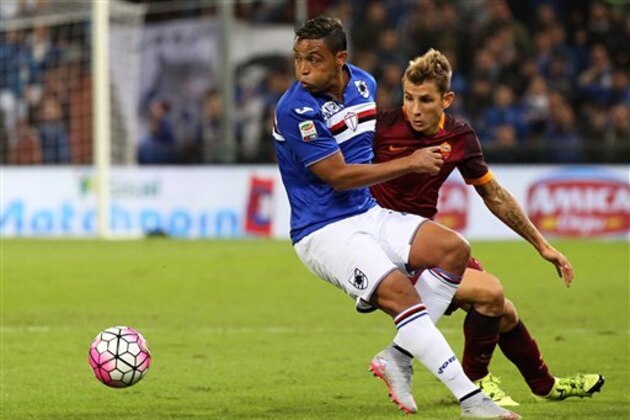 Sampdoria forward Luis Fernando Fruto Muriel, left, and Roma defender Lucas Digne, fight for the ball during a Serie A soccer match between Sampdoria and Roma, in Genoa, Italy, Wednesday, Sept. 23, 2015. (AP Photo/Carlo Baroncini)