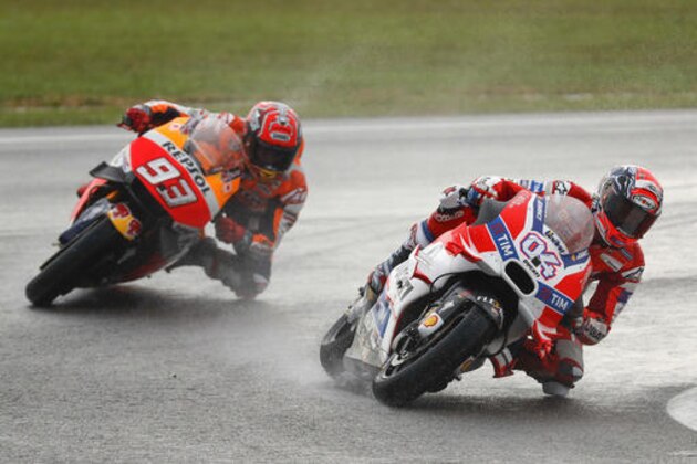 Ducati MotoGP rider Andrea Dovizioso, right, of Italy, enters a curve, followed by Honda MotoGP rider Marc Marquez of Spain during the Malaysian Motorcycle Grand Prix in Sepang, Malaysia, Sunday, Oct. 30, 2016. Dovisioso won the race while Marquez finished 11th. (AP Photo/Vincent Thian)