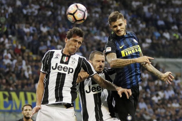 Inter Milan's Mauro Icardi, right, scores on a header past Juventus' Mario Mandzukic, left, and Leonardo Bonucci, center, during the Serie A soccer match between Inter Milan and Juventus at the San Siro stadium in Milan, Italy, Sunday, Sept. 18, 2016. (AP Photo/Antonio Calanni) Inter Milan's Mauro Icardi, right, scores on a header past Juventus' Mario Mandzukic, left, and Leonardo Bonucci, center, during the Serie A soccer match between Inter Milan and Juventus at the San Siro stadium in Milan, Italy, Sunday, Sept. 18, 2016. (AP Photo/Antonio Calanni)
