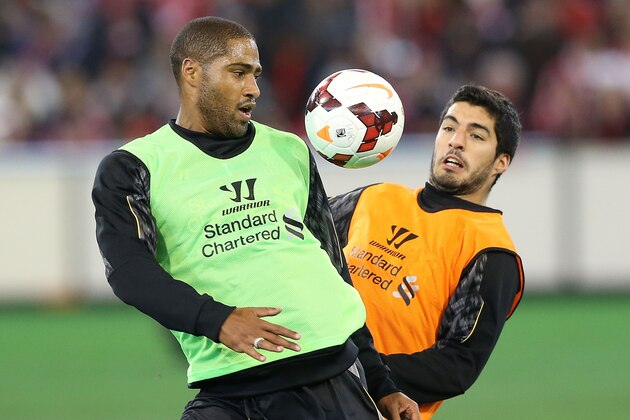 MELBOURNE, AUSTRALIA - JULY 23:  Glen  Johnson (L) and Luis Suarez contest for the ball during a Liverpool FC training session at Melbourne Cricket Ground on July 23, 2013 in Melbourne, Australia.  (Photo by Michael Dodge/Getty Images)