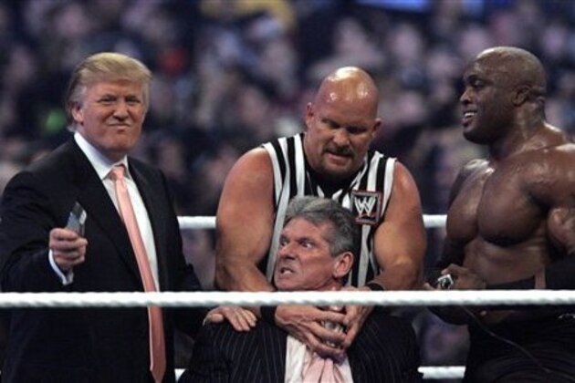 WWE Chairman Vince McMahon, center, held by