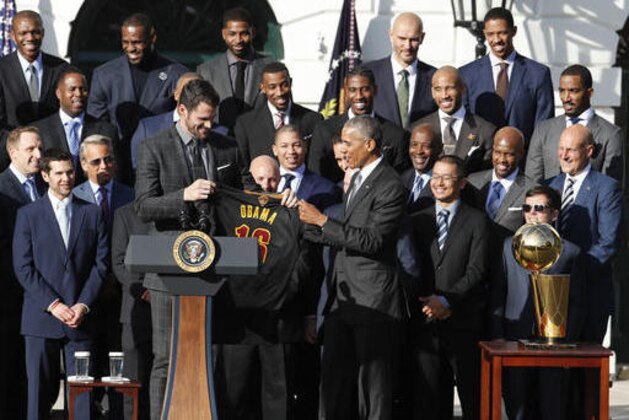 President Barack Obama accepts a team basketball jersey from Cleveland Cavaliers team members Kevin Love, left, as the president honored the 2016 NBA Champions Cleveland Cavaliers basketball team during a ceremony on the South Lawn of the White House in Washington, Thursday, Nov. 10, 2016. (AP Photo/Pablo Martinez Monsivais)