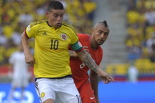Colombia's midfielder James Rodriguez (L) is marked by Chile's midfielder Arturo Vidal during their 2018 FIFA World Cup qualifier football match in Barranquilla, Colombia, on November 10, 2016. / AFP / LUIS ROBAYO        (Photo credit should read LUIS ROBAYO/AFP/Getty Images)