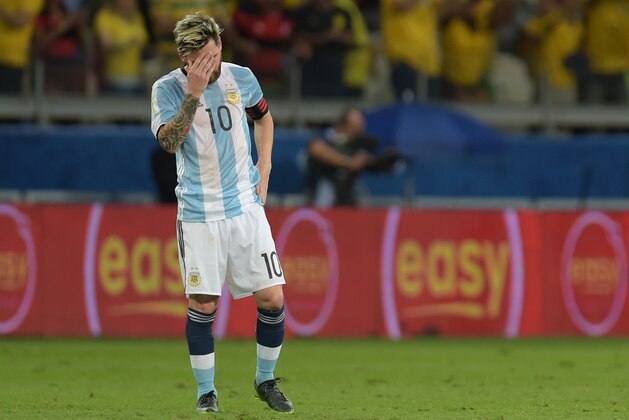 Argentina's Lionel Messi gestures as players of Brazil celebrate Neymar's goal during their 2018 FIFA World Cup qualifier football match in Belo Horizonte, Brazil, on November 10, 2016. / AFP / AFP AND DOUGLAS MAGNO / DOUGLAS MAGNO        (Photo credit should read DOUGLAS MAGNO/AFP/Getty Images)