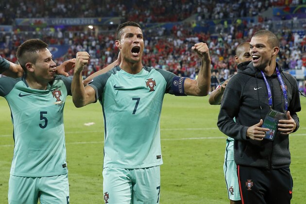 (L-R) Raphael Guerreiro of Portugal, Cristiano Ronaldo of Portugal, Pepe of Portugal during the UEFA EURO semi-final match between Portugal and Wales on July 6, 2016 at the Stade de Lyon in Lyon, France.(Photo by VI Images via Getty Images)