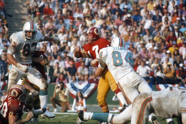 LOS ANGELES, CA - JANUARY 14: Billy Kilmer #17 of the Washington Redskins gets his pass off under pressure from Vern Den Herder #83 and Bill Stanfill #84 of the Miami Dolphins during Super Bowl VII at the Los Angeles Memorial Coliseum in Los Angeles, California, January 14, 1973. The Dolphins won the Super Bowl 14-7. (Photo by Focus on Sport/Getty Images) LOS ANGELES, CA - JANUARY 14: Billy Kilmer #17 of the Washington Redskins gets his pass off under pressure from Vern Den Herder #83 and Bill Stanfill #84 of the Miami Dolphins during Super Bowl VII at the Los Angeles Memorial Coliseum in Los Angeles, California, January 14, 1973. The Dolphins won the Super Bowl 14-7. (Photo by Focus on Sport/Getty Images)