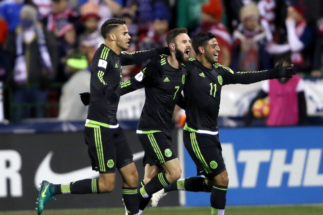 Nov 11, 2016; Columbus, OH, USA;  Mexico's Miguel Layun (center) is congratulated after his early goal by teammate Carlos Vela (right) and Diego Reyes (left) during first half action of the Team USA against Mexico match at MAPFRE Stadium. Mandatory Credit: Joe Maiorana-USA TODAY Sports