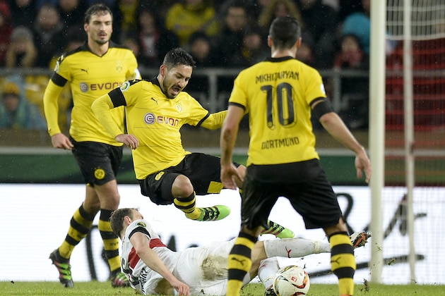 Stuttgart's defender Georg Niedermeier (on ground) and Dortmund's  midfielder Ilkay Guendogan vie for the ball as defender Mats Hummels (L) and Armenian midfielder Henrikh Mkhitaryan (R) watch on during the German Cup ( Pokal ) quarter final football match VfB Stuttgart v Borussia Dortmund on February 9, 2016 in Stuttgart. / AFP / Thomas Kienzle / RESTRICTIONS: ACCORDING TO DFB RULES IMAGE SEQUENCES TO SIMULATE VIDEO IS NOT ALLOWED DURING MATCH TIME. MOBILE (MMS) USE IS NOT ALLOWED DURING AND FOR FURTHER TWO HOURS AFTER THE MATCH.
== RESTRICTED TO EDITORIAL USE == 
FOR MORE INFORMATION CONTACT DFB DIRECTLY AT +49 69 67880
 /         (Photo credit should read THOMAS KIENZLE/AFP/Getty Images)