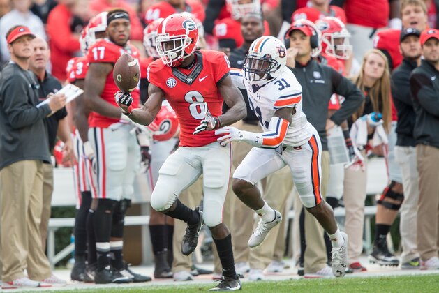 ATHENS, GA - NOVEMBER 12: Wide receiver Riley Ridley #8 of the Georgia Bulldogs catches a pass in front of defensive back Javaris Davis #31 of the Auburn Tigers at Sanford Stadium on November 12, 2016 in Athens, Georgia. (Photo by Michael Chang/Getty Images)