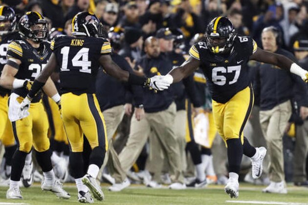 Iowa defensive lineman Jaleel Johnson (67) celebrates with teammate Desmond King (14) after tackling Michigan running back De'Veon Smith for a safety during the first half of an NCAA college football game, Saturday, Nov. 12, 2016, in Iowa City, Iowa. (AP Photo/Charlie Neibergall)