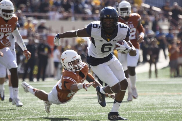Nov 12, 2016; Austin, TX, USA; (Editors note: Caption correction) West Virginia wide receiver Daikiel Shorts, Jr., (6) avoids a tackle by Texas Longhorns cornerback John Bonney (24) during the first quarter at Darrell K Royal-Texas Memorial Stadium. Mandatory Credit: Brendan Maloney-USA TODAY Sports