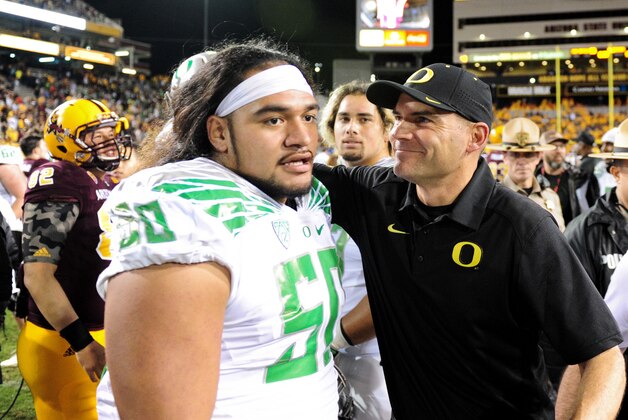 Oct 29, 2015; Tempe, AZ, USA; Oregon Ducks head coach Mark Helfrich celebrates with Oregon Ducks defensive lineman Austin Maloata (50) after beating the Arizona State Sun Devils 61-55 in triple overtime at Sun Devil Stadium. Mandatory Credit: Matt Kartozian-USA TODAY Sports