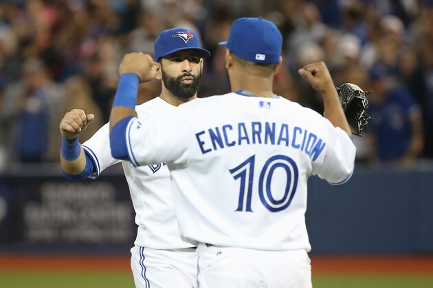 TORONTO, CANADA - AUGUST 5: Jose Bautista #19 of the Toronto Blue Jays celebrates a victory with Edwin Encarnacion #10 after MLB game action against the Minnesota Twins on August 5, 2015 at Rogers Centre in Toronto, Ontario, Canada. (Photo by Tom Szczerbowski/Getty Images)