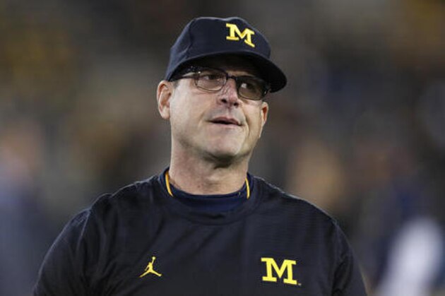 Michigan head coach Jim Harbaugh stands on the field before an NCAA college football game against Iowa, Saturday, Nov. 12, 2016, in Iowa City, Iowa. (AP Photo/Charlie Neibergall)