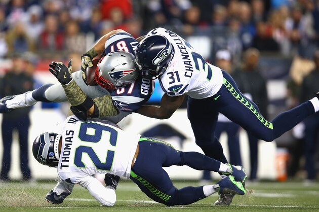 FOXBORO, MA - NOVEMBER 13: Rob Gronkowski #87 of the New England Patriots is tackled after making a catch by Earl Thomas #29 and Kam Chancellor #31 of the Seattle Seahawks during the second quarter of a game at Gillette Stadium on November 13, 2016 in Foxboro, Massachusetts.  (Photo by Adam Glanzman/Getty Images)