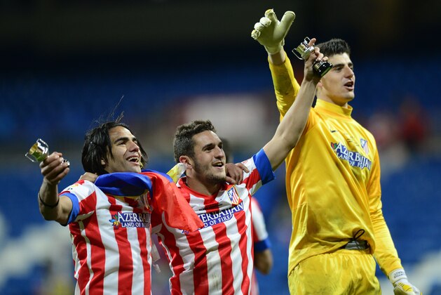 Atletico Madrid's Colombian forward Radamel Falcao (L), Atletico Madrid's midfielder Koke (C) and Atletico Madrid's Belgian goalkeeper Thibaut Courtois celebrate after winning the Spanish King's Cup (Copa del Rey) final football match Real Madrid vs Atletico de Madrid at Santiago Bernabeu stadium in Madrid on May 18, 2013. Atletico Madrid won the match 2-1.  AFP PHOTO / JAVIER SORIANO        (Photo credit should read JAVIER SORIANO/AFP/Getty Images)