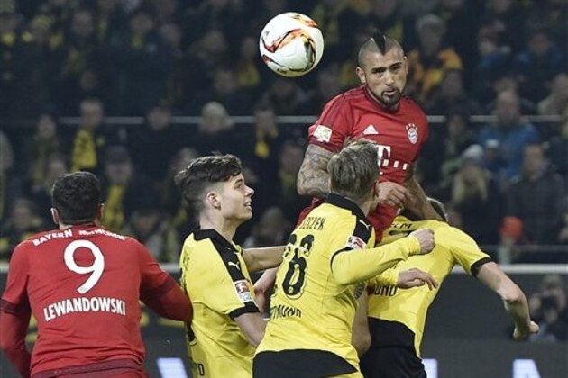 Bayern's Arturo Vidal jumps for the ball against Dortmund's defense the German Bundesliga soccer match between Borussia Dortmund and Bayern Munich, in Dortmund, Germany, Saturday, March 5, 2016. The match ended 0-0. (AP Photo/Martin Meissner)