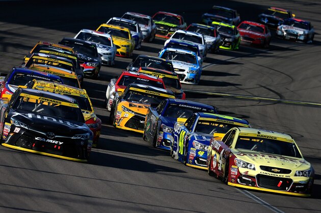 KANSAS CITY, KS - OCTOBER 16:  Kevin Harvick, driver of the #4 Outback Chevrolet, and Carl Edwards, driver of the #19 Xfinity Toyota, lead the field to the final restart during the NASCAR Sprint Cup Series Hollywood Casino 400 at Kansas Speedway on October 16, 2016 in Kansas City, Kansas.  (Photo by Chris Trotman/Getty Images)