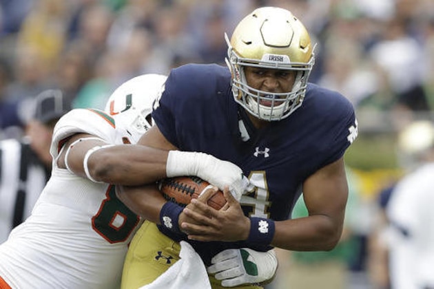 Notre Dame quarterback DeShone Kizer (14) is tackled by Miami 's RJ McIntosh during the first half of an NCAA college football game Saturday, Oct. 29, 2016, in South Bend, Ind. (AP Photo/Darron Cummings)