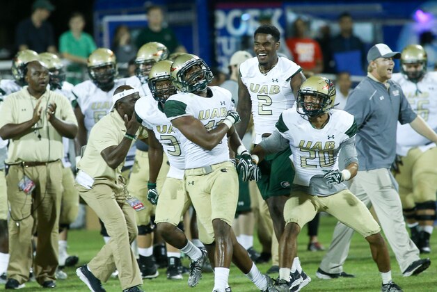 In this Thursday, Aug. 25, 2016, photo, UAB football head coach Bill Clark blows a whistle to indicate a change in practice in Birmingham, Ala.