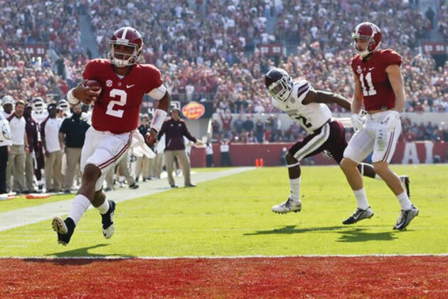 Alabama quarterback Jalen Hurts, left, scores a touchdown during the first half of an NCAA college football game against Mississippi State, Saturday, Nov. 12, 2016, in Tuscaloosa, Ala. (AP Photo/Brynn Anderson)