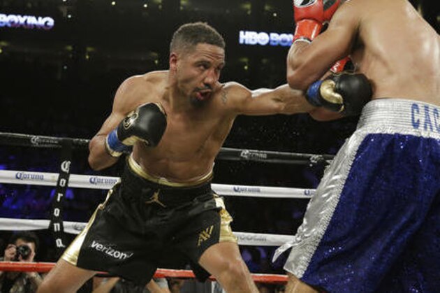 Andre Ward, left, punches Alexander Brand, of Colombia, right, during the 12th round of their light heavyweight boxing match Saturday, Aug. 6, 2016, in Oakland, Calif. Ward won the fight in a unanimous decision. (AP Photo/Eric Risberg)