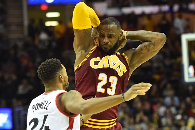 Nov 15, 2016; Cleveland, OH, USA; Cleveland Cavaliers forward LeBron James (23) holds the ball from Toronto Raptors guard Norman Powell (24) during the second quarter at Quicken Loans Arena. Mandatory Credit: Ken Blaze-USA TODAY Sports