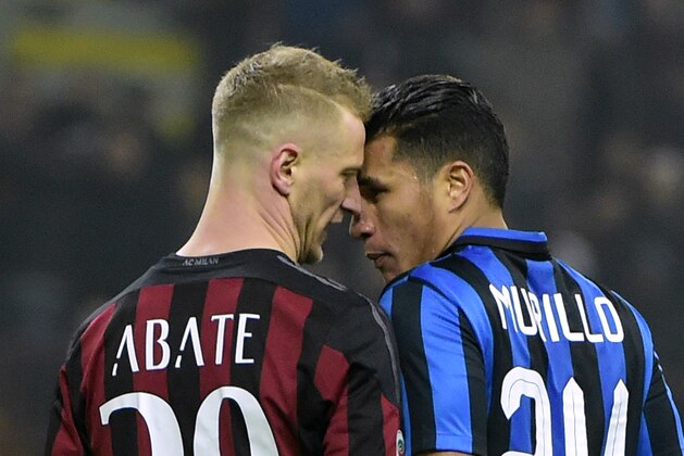 AC Milan's Italian defender Ignazio Abate (L) argues with Inter Milan's Colombian defender Jeison Murillo during the Italian Serie A football match between AC Milan and Inter Milan at San Siro Stadium in Milan on January 31, 2016. / AFP / OLIVIER MORIN        (Photo credit should read OLIVIER MORIN/AFP/Getty Images)
