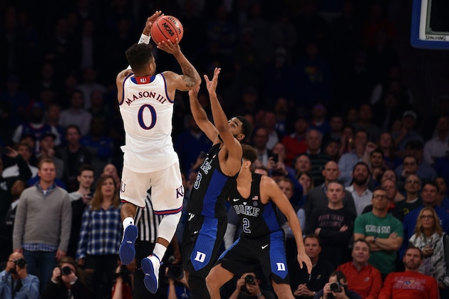 NEW YORK, NY - NOVEMBER 15: Frank Mason III #0 of the Kansas Jayhawks puts up the game-winning shot against Matt Jones #13 of the Duke Blue Devils with three seconds remaining in the game during the State Farm Champions Classic at Madison Square Garden on November 15, 2016 in New York City. Kansas won 77-75. (Photo by Lance King/Getty Images)